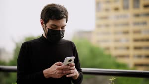 Stock Video Man With Face Mask Sending Audios By Cell Phon Animated Wallpaper