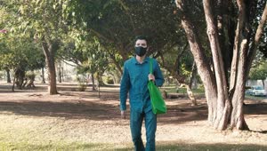 Stock Video Man With Face Mask In A Park After Shoppin Animated Wallpaper