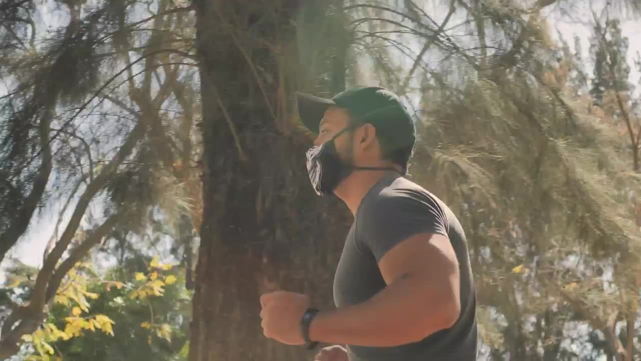 Download Stock Video Man With Face Mask Running At The Par Animated Wallpaper