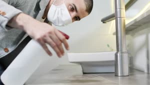 Stock Video Man With Face Mask Cleaning The Surface Of A Bathroo Animated Wallpaper
