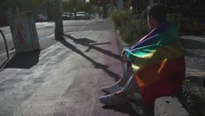 Stock Video Man With A Rainbow Flag Sits On The Stree Animated Wallpaper
