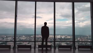 Stock Video Man Wearing A Suit Looking Out Towards A Cit Animated Wallpaper