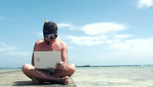 Stock Video Man Wearing A Snorkel While Using A Lapto Animated Wallpaper