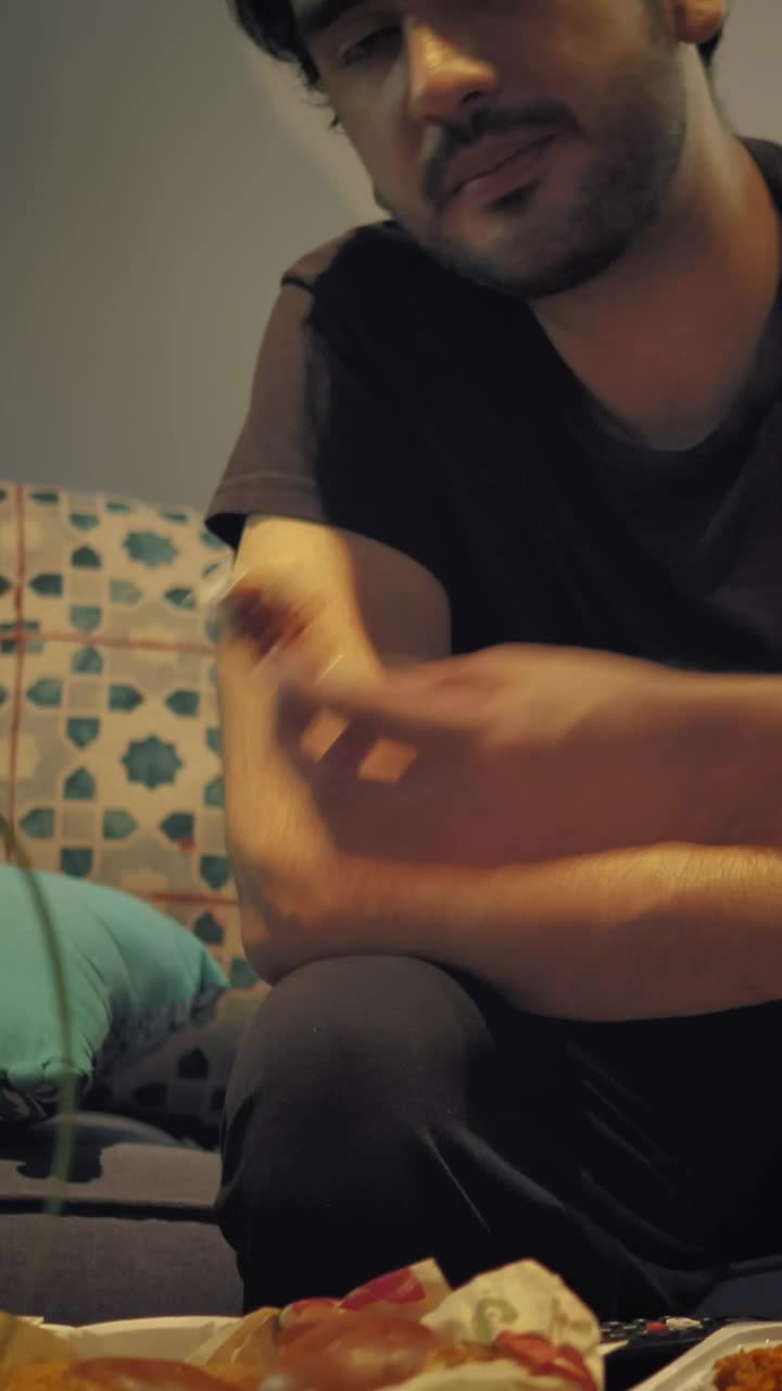 Download Stock Video Man Watching Tv While Eating Nuggets With Dressin Animated Wallpaper