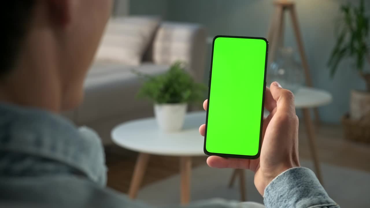 Download Stock Video Man Watching To A Green Screen Smartphon Animated Wallpaper