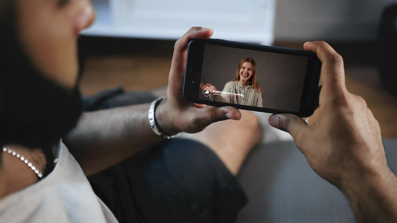 Download Stock Video Man Watching A Video On His Smartphon Animated Wallpaper