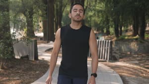 Stock Video Man Warming Up In A Park Before Exercisin Animated Wallpaper