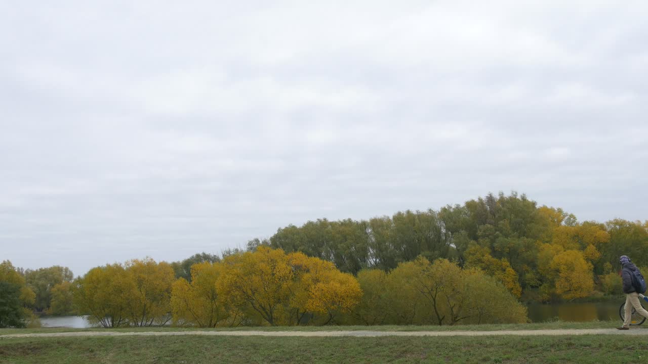 Download Stock Video Man Walking Through The Countryside With His Bik Animated Wallpaper