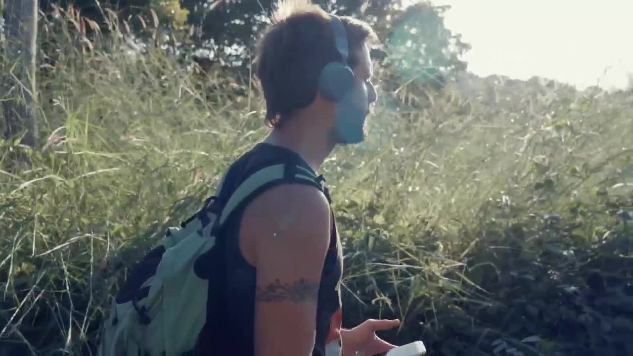 Download Stock Video Man Walking In Nature With Music On His Headphone Animated Wallpaper