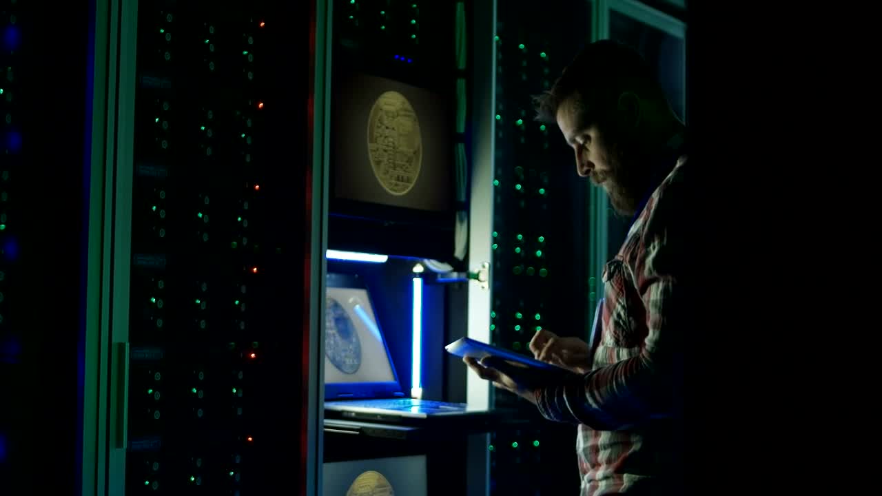 Download Stock Video Man Using A Laptop In A Dark Room Data Cente Animated Wallpaper