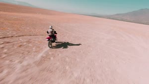 Stock Video Man Traveling Through The Desert On His Motorcycl Animated Wallpaper