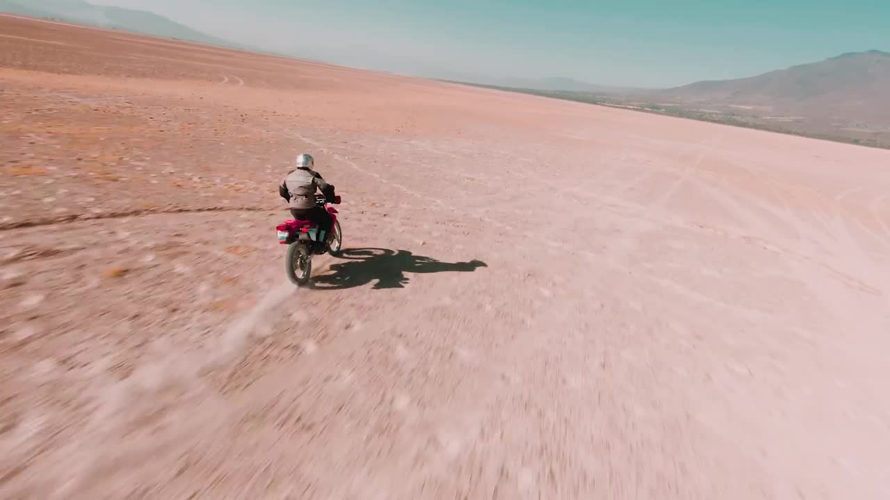 Download Stock Video Man Traveling Through The Desert On His Motorcycl Animated Wallpaper