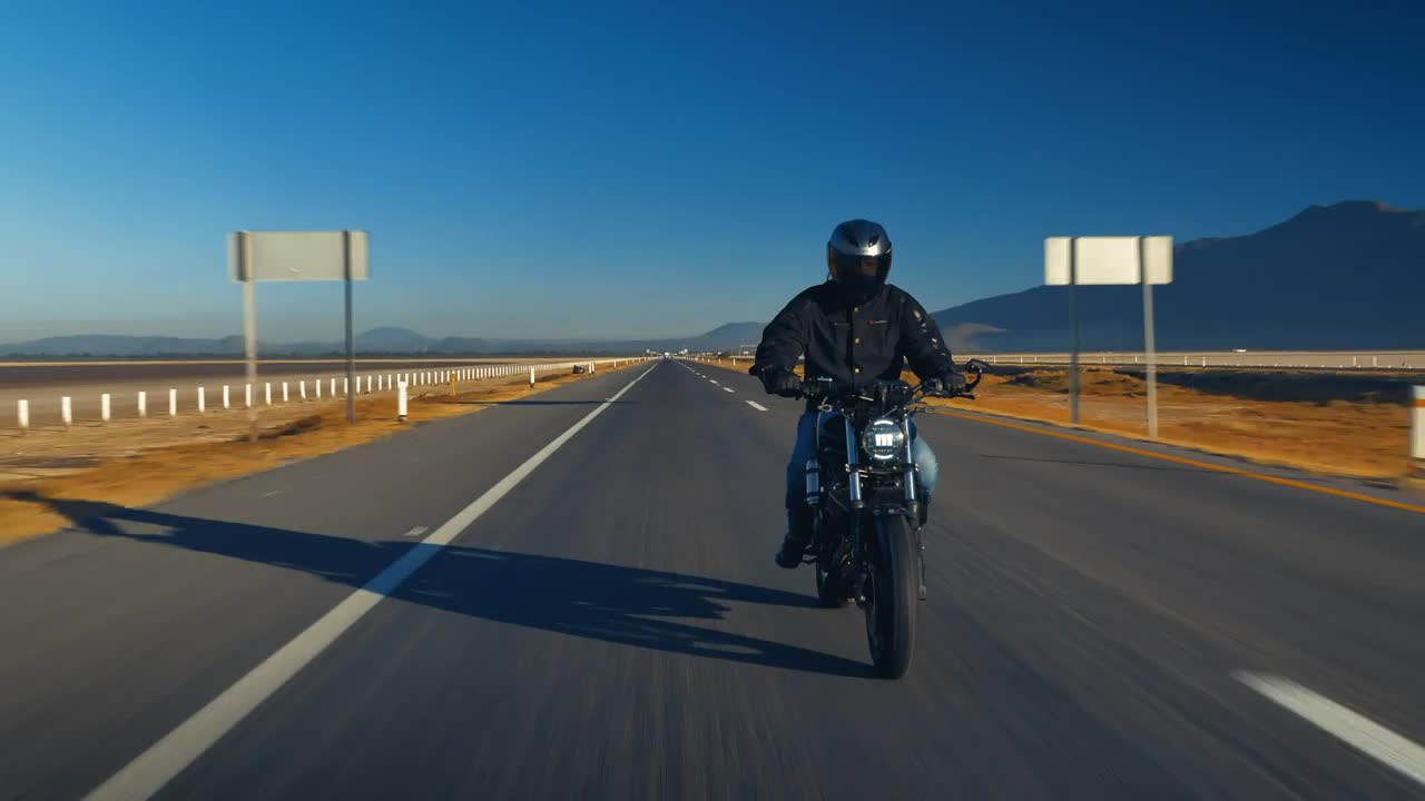 Download Stock Video Man Traveling By Motorcycle On An Empty Roa Animated Wallpaper