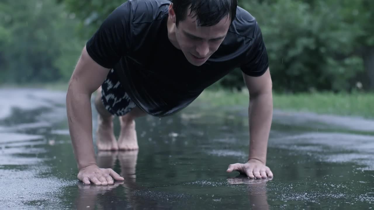 Download Stock Video Man Training Outdoors While Rainin Animated Wallpaper