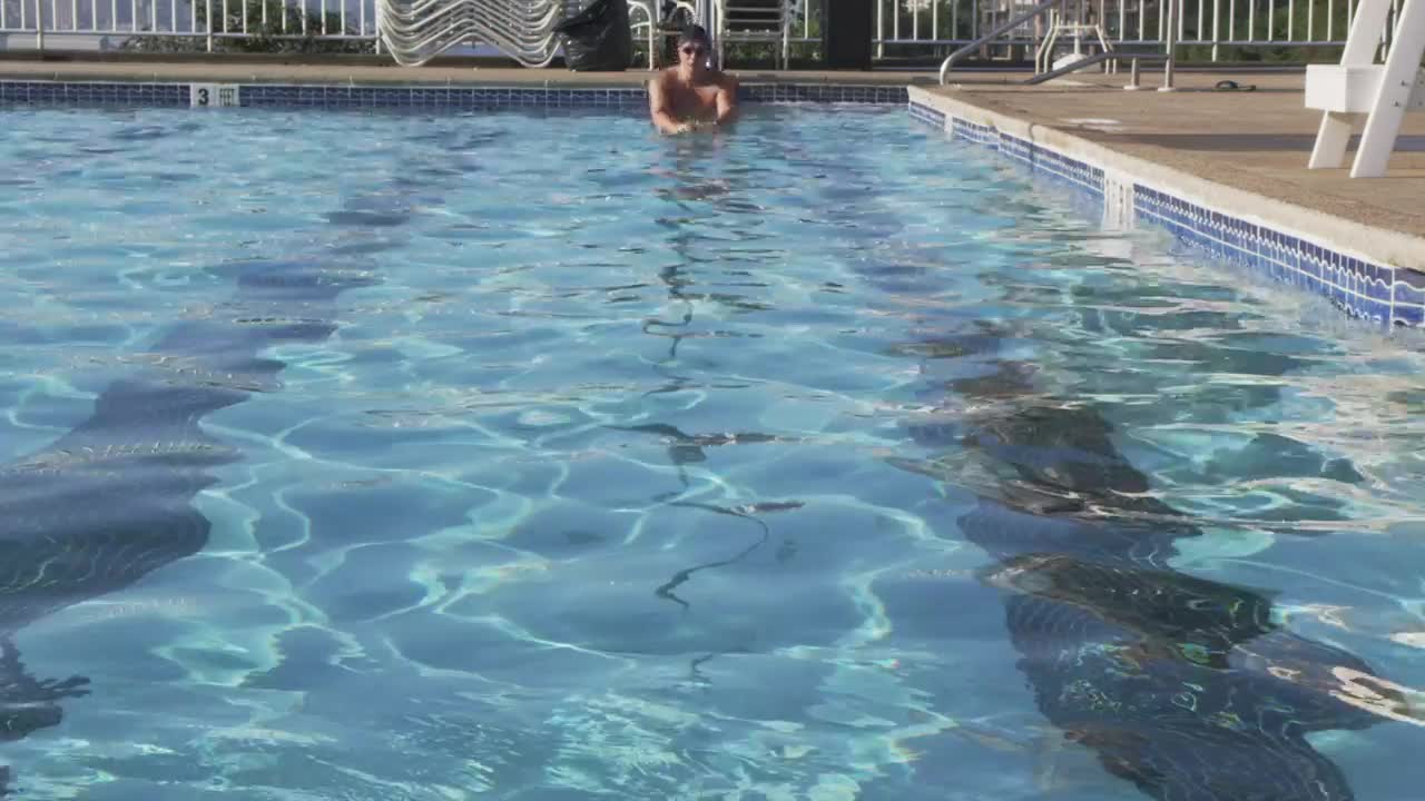 Download Stock Video Man Swimming In An Outdoor Poo Animated Wallpaper