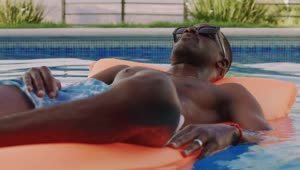 Stock Video Man Sunbathing On A Float Animated Wallpaper