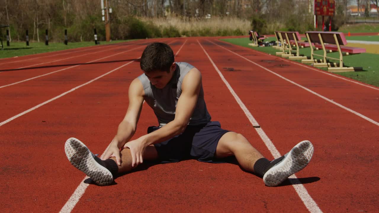 Download Stock Video Man Stretching At A Running Trac Animated Wallpaper