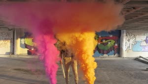Stock Video Man Standing Between Colorful Smoke Bomb Animated Wallpaper
