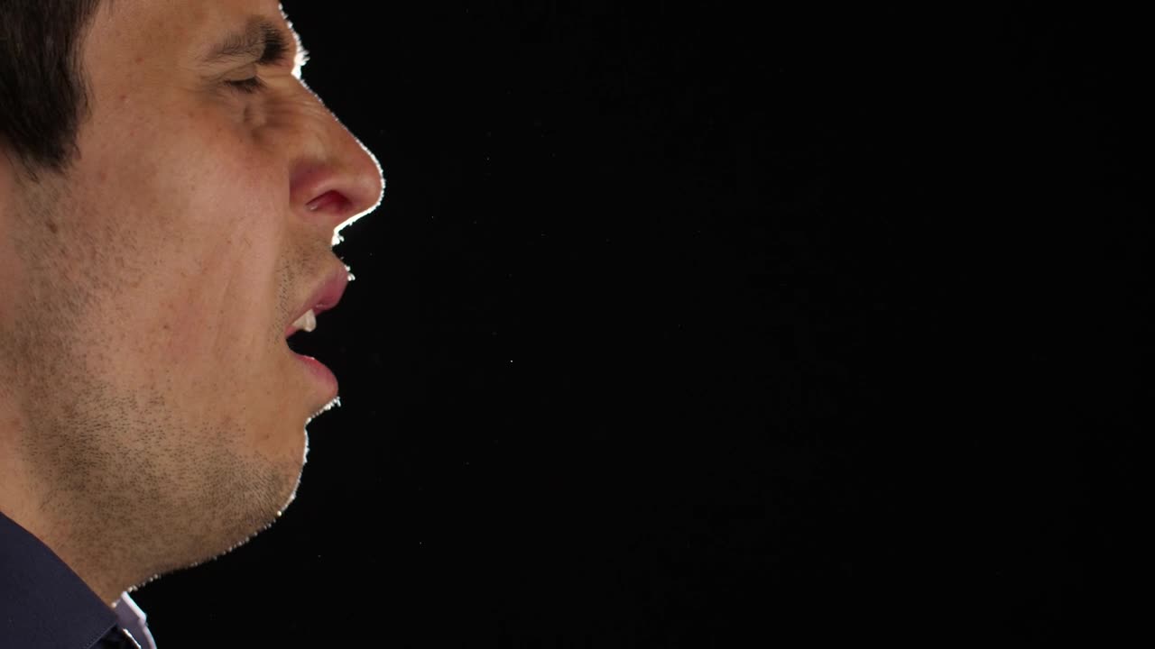 Download Stock Video Man Sneezing With Dark Backgroun Animated Wallpaper