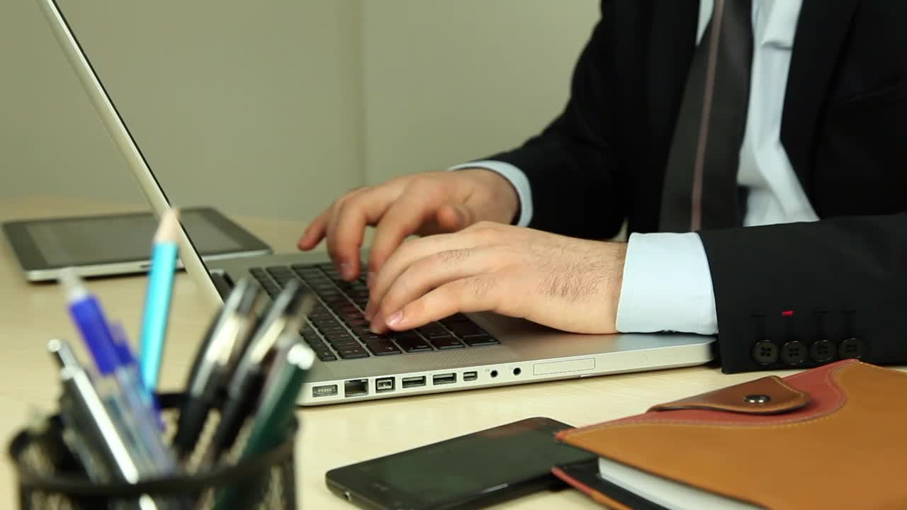 Download Stock Video Man Sitting On A Couch Working On A Lapto Animated Wallpaper