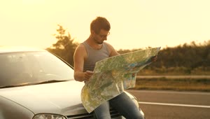 Stock Video Man Sitting In His Car Looks At A Map O Animated Wallpaper