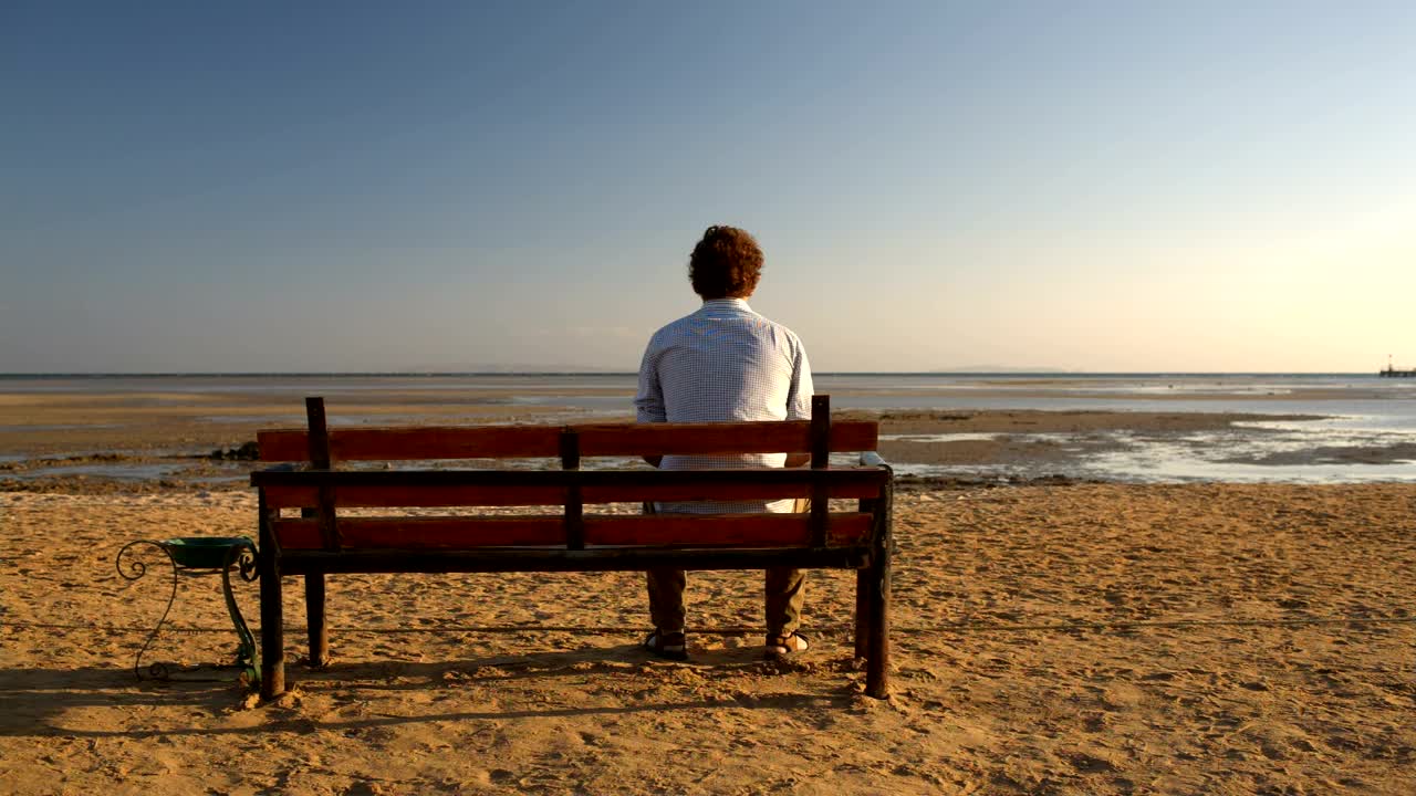 Download Stock Video Man Sitting Alone On A Benc Animated Wallpaper