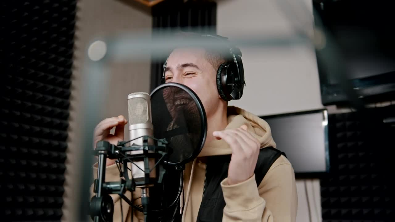 Download Stock Video Man Singing Into A Microphone In An Audio Boot Animated Wallpaper