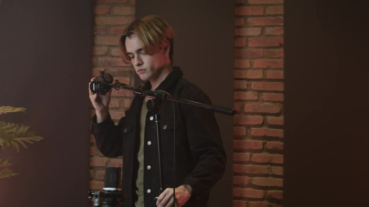 Download Stock Video Man Setting Up His Microphon Animated Wallpaper