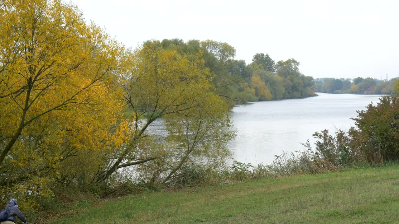 Download Stock Video Man Riding His Bike By The Rive Animated Wallpaper