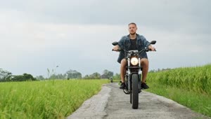 Stock Video Man Rides Motorcycle Chopper On Farm Field Pat Animated Wallpaper
