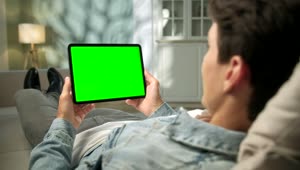 Stock Video Man Relaxing With Green Screen Tablet In Neutral Roo Animated Wallpaper