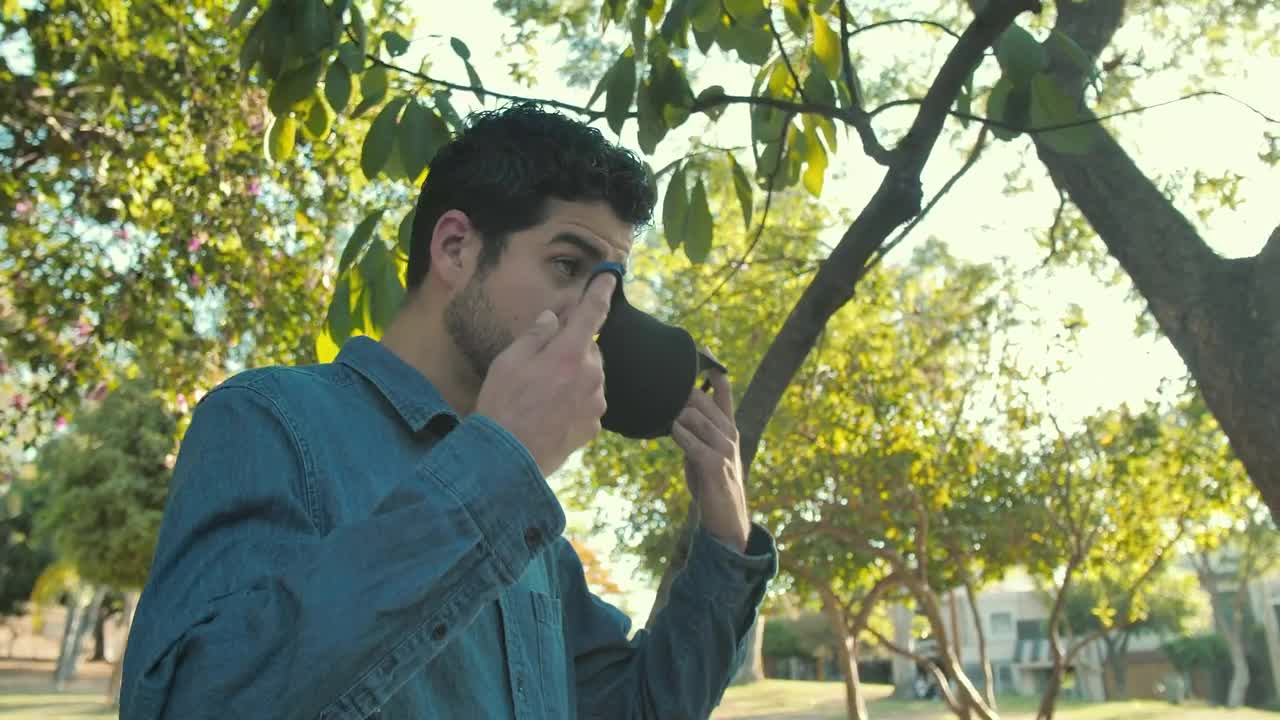 Download Stock Video Man Putting On A Mas Animated Wallpaper