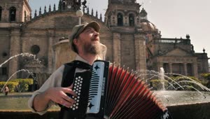Stock Video Man Plays An Accordion In Front Of A Fountain An Animated Wallpaper