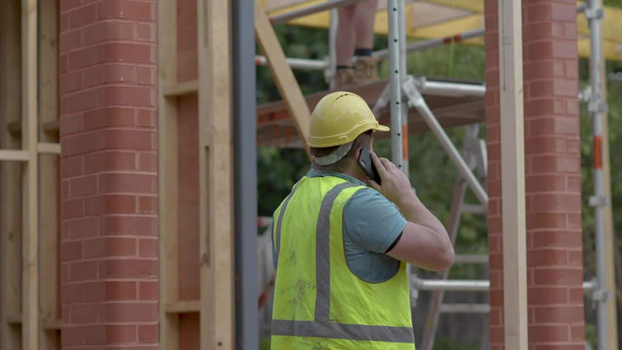 Download Stock Video Man On The Phone Near A Construction Sit Animated Wallpaper