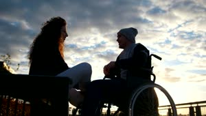 Stock Video Man On A Wheelchair Talking To A Young Woman I Animated Wallpaper
