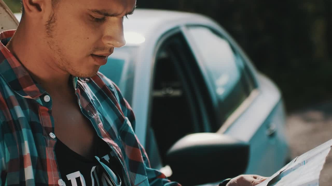 Download Stock Video Man Looking At A Map By His Broken Ca Animated Wallpaper