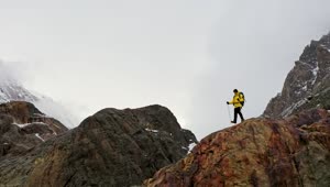 Stock Video Man In Yellow Coat Cheers On Mountain Ridg Animated Wallpaper