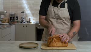 pastry chef cutting a loaf into slices 43015