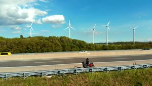 Stock Video Motorcycle On The Highway With A Wind Farm Behind Live Wallpaper