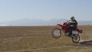 Stock Video Motorcyclist Doing A Wheelie In The Desert Live Wallpaper