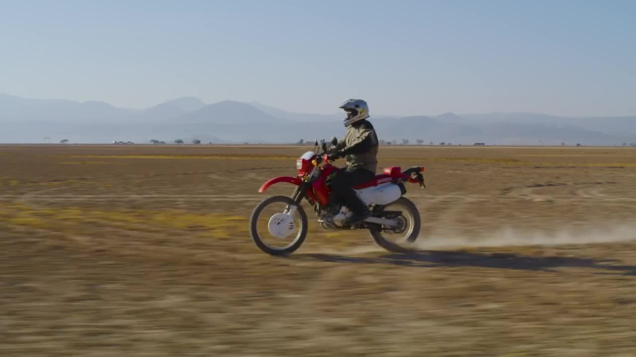 Download Stock Video Motorcyclist Traveling Through The Desert Live Wallpaper