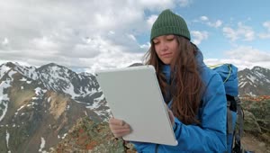 Stock Video Mountaineer Girl Using A Tablet In The Mountains Live Wallpaper