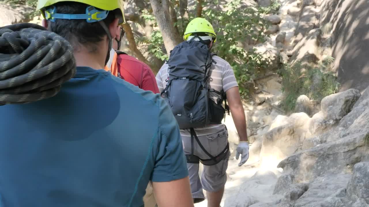 Download Stock Video Mountaineers Walking Around A Mountain In Nature Live Wallpaper