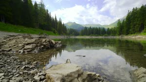 Stock Video Mountainous Area Seen From A Pond Landscape Live Wallpaper