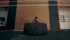 Stock Video Muscular Man Doing Crossfit Exercises With Tire Live Wallpaper