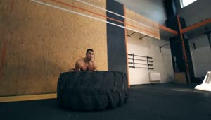 Stock Video Muscular Man Doing Crossfit With A Big Tire Live Wallpaper