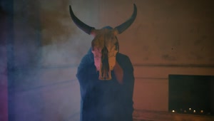 Stock Video Mysterious Person In Robe Holding A Bulls Skull Live Wallpaper