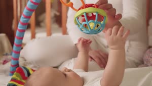 Stock Video Newborn Baby Plays With A Toy Live Wallpaper