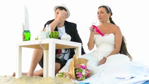 Stock Video Newlyweds On A Picnic On The Beach Live Wallpaper