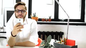 Stock Video Office Man Texting And Drinking Coffee At The Office Live Wallpaper